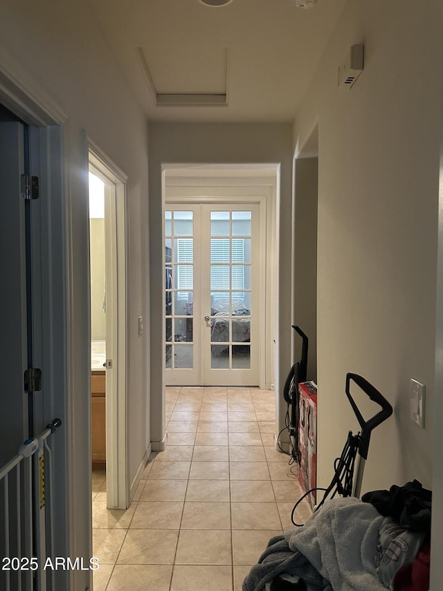 25931 W Deer Valley Rd, Buckeye, AZ 85396 - hallway featuring light tile patterned floors, french doors, and attic access