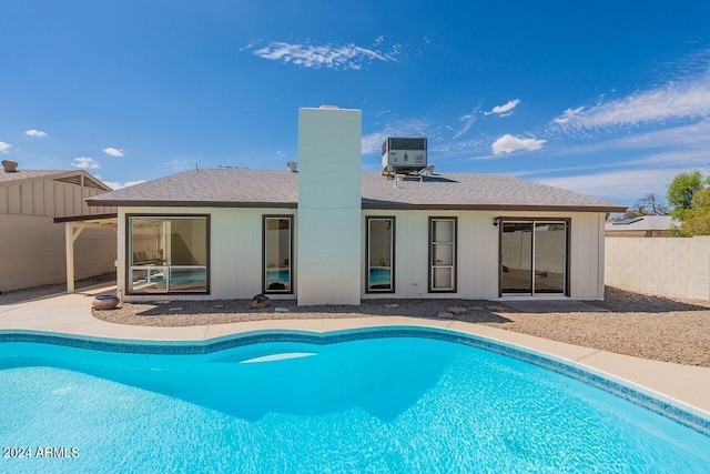 view of pool with central AC unit and a patio area