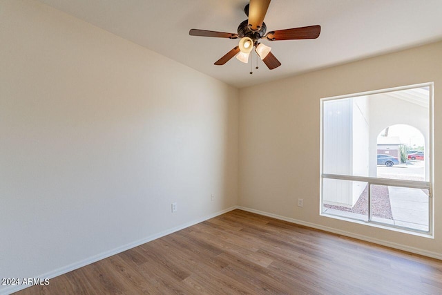 empty room with light wood-type flooring and ceiling fan