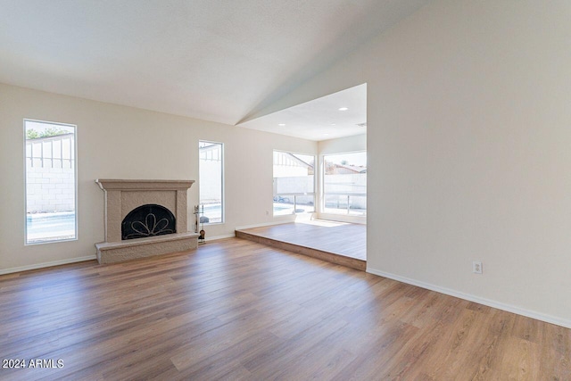 unfurnished living room featuring wood-type flooring and vaulted ceiling