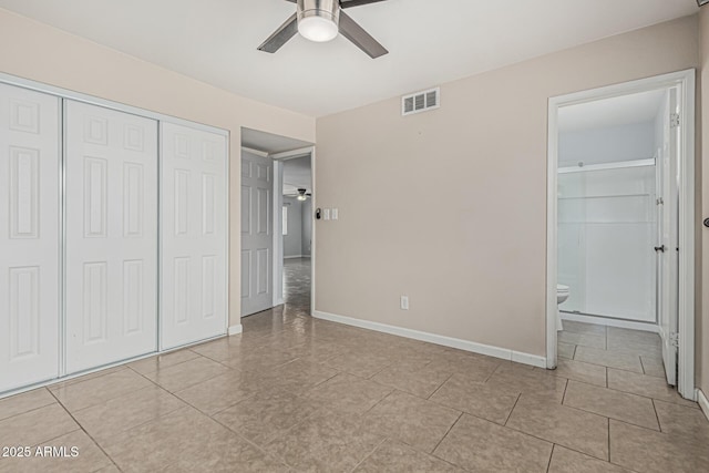 9609 N 44th Ave, Glendale, AZ 85302 - unfurnished bedroom with visible vents, baseboards, a closet, ensuite bath, and light tile patterned flooring