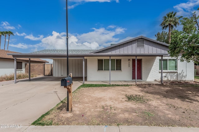 9609 N 44th Ave, Glendale, AZ 85302 - ranch-style home featuring brick siding, board and batten siding, a porch, driveway, and a carport