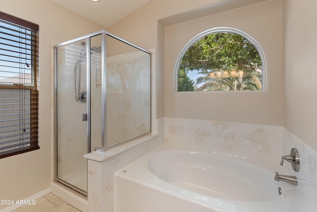 bathroom featuring shower with separate bathtub and tile flooring