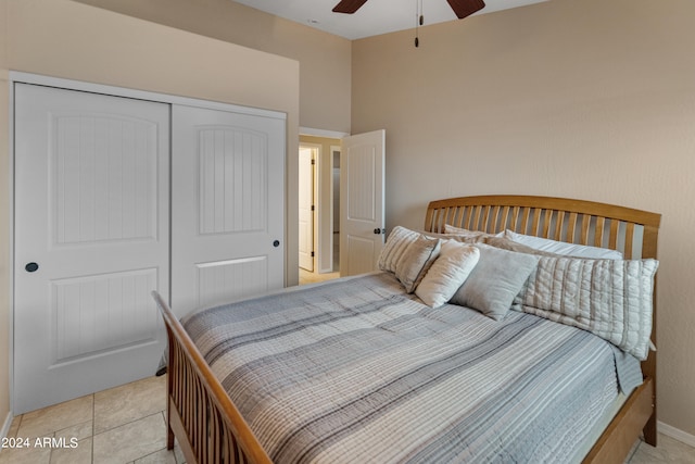 bedroom featuring a closet, ceiling fan, and light tile flooring