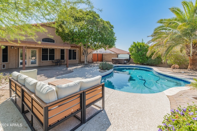 view of pool with a patio area, french doors, and an outdoor hangout area