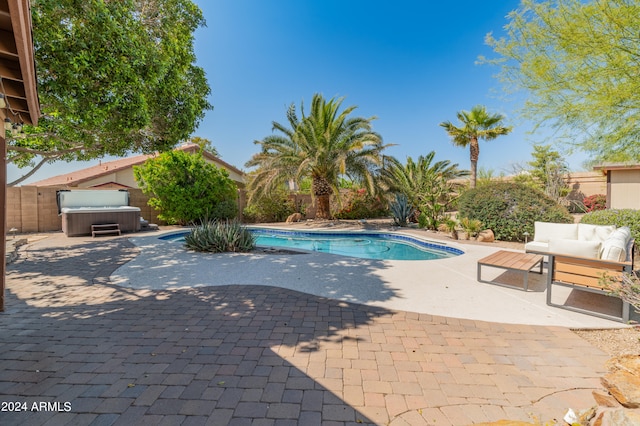 view of pool with a patio area and an outdoor living space