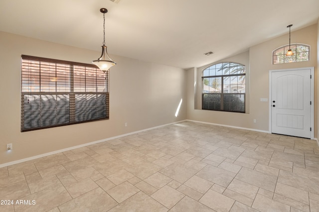 tiled entrance foyer featuring vaulted ceiling