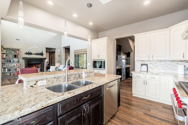kitchen with sink, white cabinets, decorative light fixtures, and dishwasher