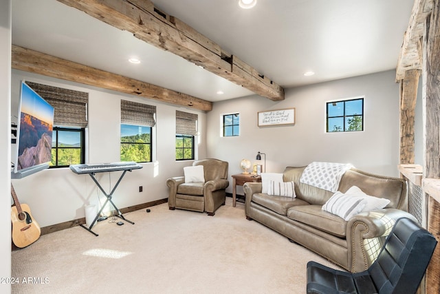 carpeted living room featuring beam ceiling