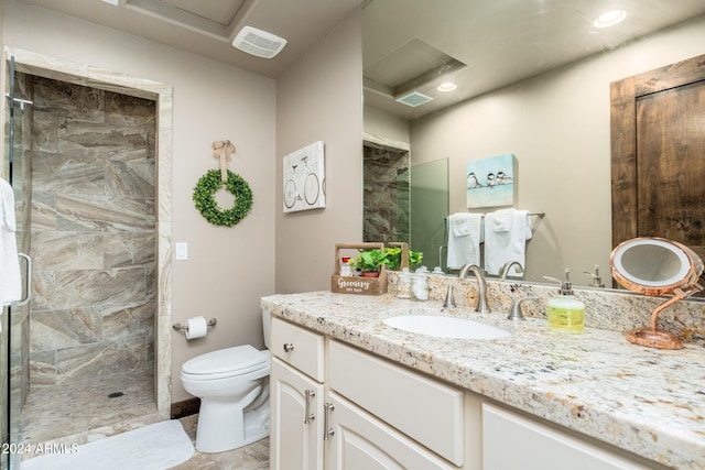 bathroom with vanity, toilet, and a shower with shower door