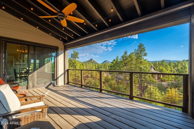 deck with a mountain view and ceiling fan