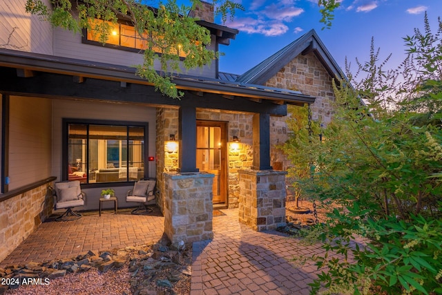 exterior entry at dusk with a patio