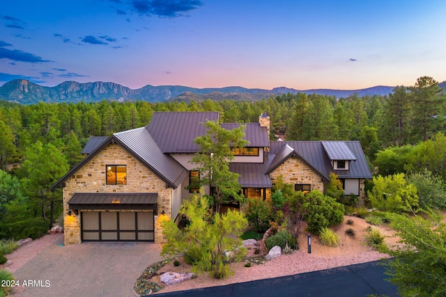 view of front of home with a mountain view and a garage