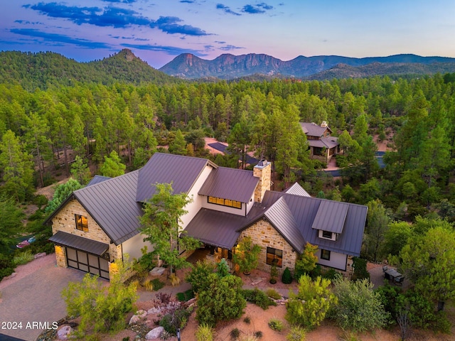 aerial view at dusk featuring a mountain view
