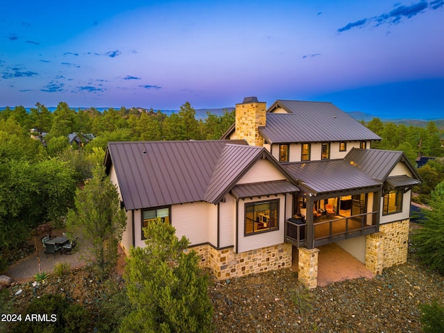 view of back house at dusk