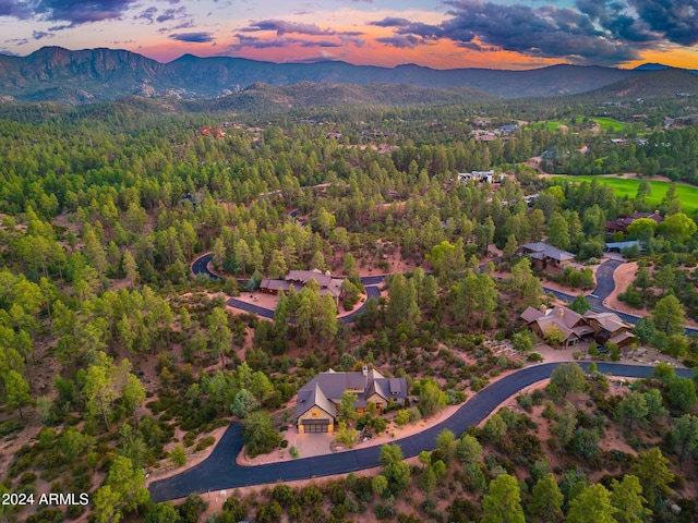 aerial view at dusk featuring a mountain view