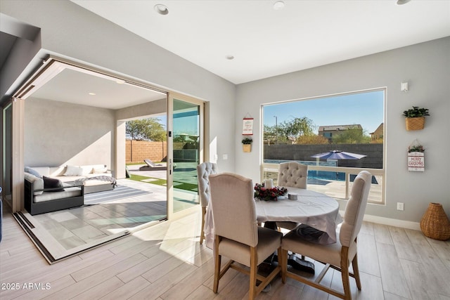 dining space with light hardwood / wood-style floors and a wealth of natural light