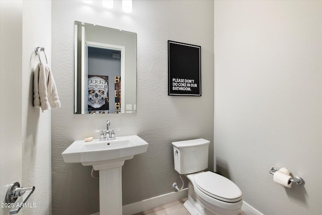 bathroom featuring sink and toilet