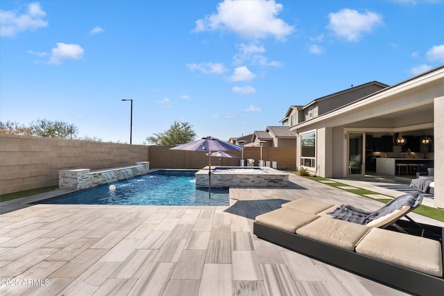 view of swimming pool featuring a patio, pool water feature, and an in ground hot tub