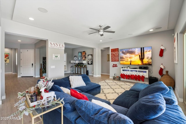 living room with wood-type flooring and ceiling fan