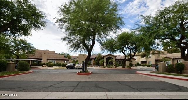9450 E Becker Ln Unit 2099, Scottsdale, AZ 85260 - view of asphalt road with curbs, a residential view, and sidewalks