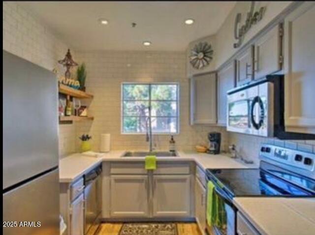 9450 E Becker Ln Unit 2099, Scottsdale, AZ 85260 - kitchen with stainless steel appliances, plenty of natural light, light countertops, and recessed lighting