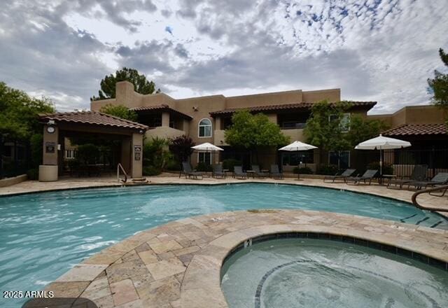 9450 E Becker Ln Unit 2099, Scottsdale, AZ 85260 - community pool featuring a community hot tub and a patio