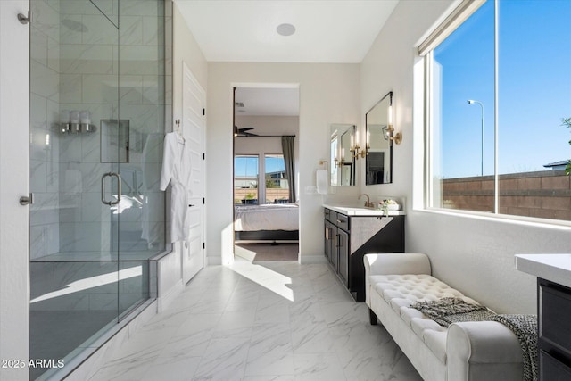 bathroom with ceiling fan, vanity, and a shower with shower door