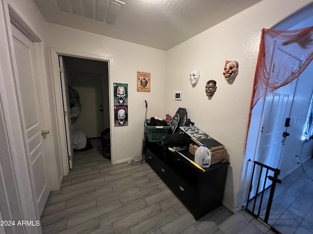 hall featuring visible vents and wood finish floors