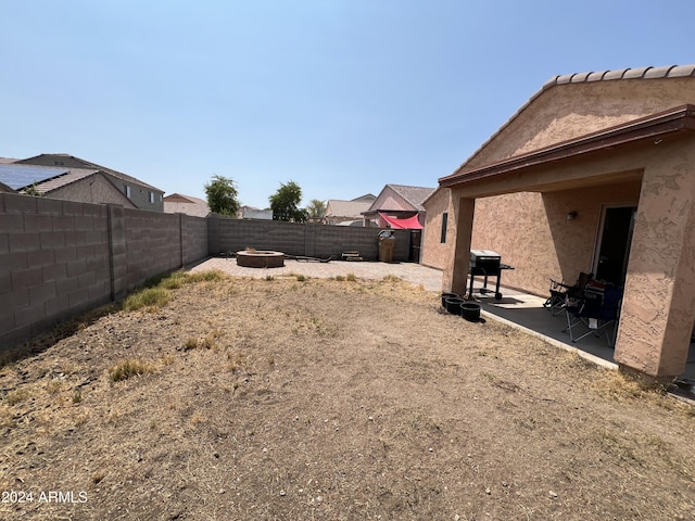 view of yard featuring a patio area, a fire pit, and a fenced backyard