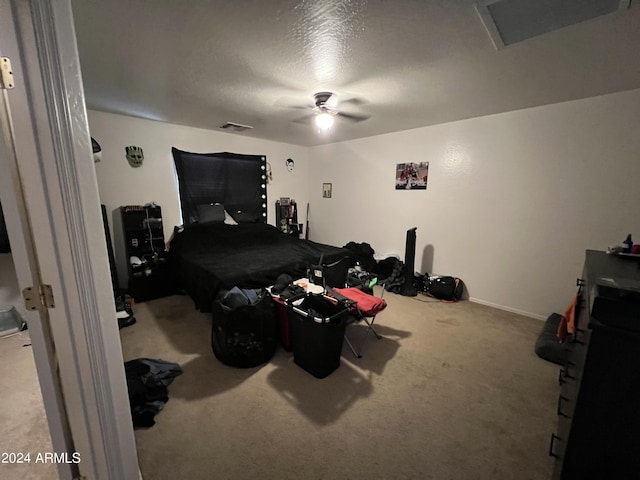 bedroom featuring a textured ceiling, a ceiling fan, and carpet floors