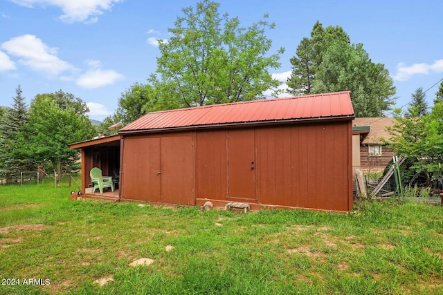 view of outbuilding featuring a lawn