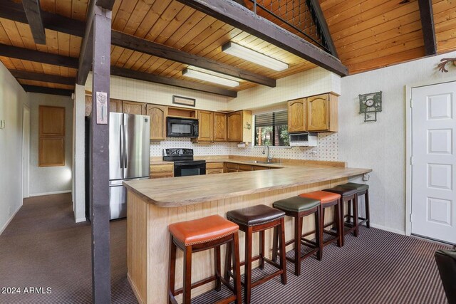 kitchen with sink, plenty of natural light, black appliances, and backsplash