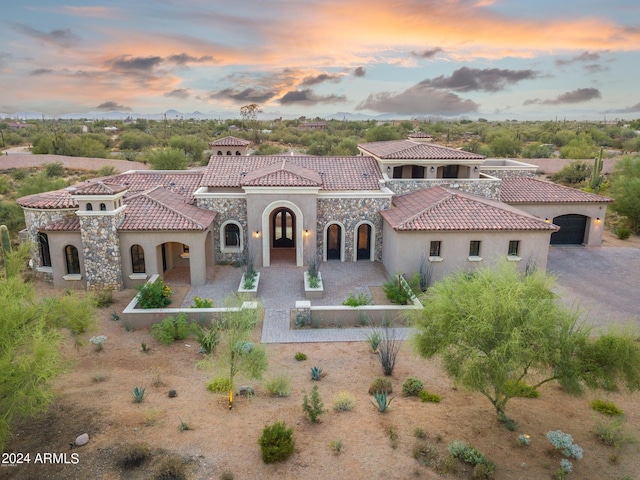 7254 E Sonoran Trl, Scottsdale, AZ 85266 - mediterranean / spanish-style house featuring stucco siding, a tiled roof, and stone siding