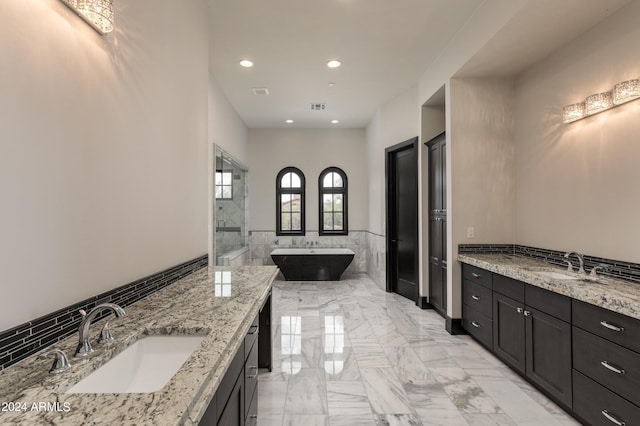 7254 E Sonoran Trl, Scottsdale, AZ 85266 - full bath featuring a freestanding tub, two vanities, marble finish floors, tile walls, and recessed lighting
