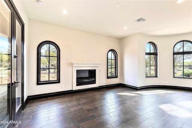 7254 E Sonoran Trl, Scottsdale, AZ 85266 - unfurnished living room featuring healthy amount of natural light, dark wood-type flooring, recessed lighting, and a glass covered fireplace