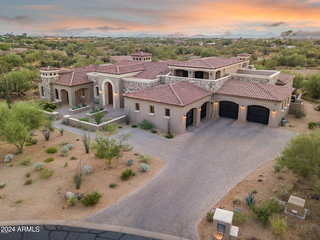 7254 E Sonoran Trl, Scottsdale, AZ 85266 - mediterranean / spanish-style house with a garage, decorative driveway, stucco siding, and a tiled roof