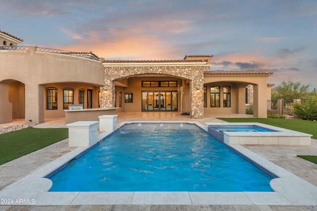 7254 E Sonoran Trl, Scottsdale, AZ 85266 - back of house featuring a patio, stucco siding, a tiled roof, and a pool with connected hot tub