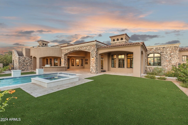 7254 E Sonoran Trl, Scottsdale, AZ 85266 - back of property at dusk with stucco siding, a patio, a lawn, and a tiled roof