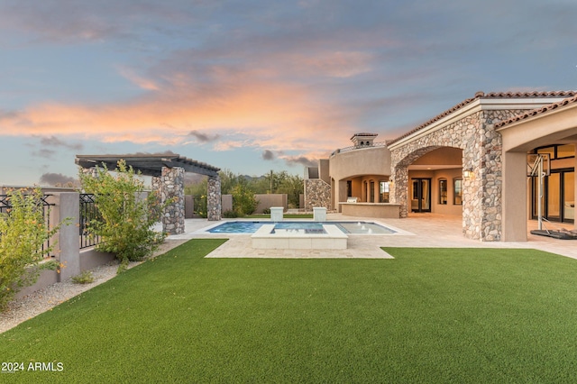 7254 E Sonoran Trl, Scottsdale, AZ 85266 - back of property at dusk with a patio, a fenced backyard, stone siding, stucco siding, and a pool with connected hot tub