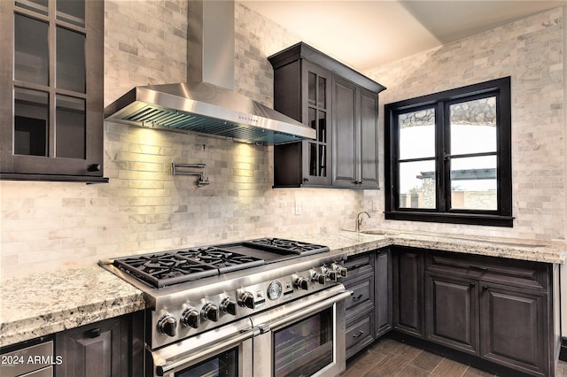 7254 E Sonoran Trl, Scottsdale, AZ 85266 - kitchen with double oven range, wall chimney range hood, decorative backsplash, dark wood finished floors, and light stone countertops