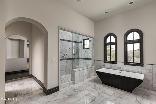 7254 E Sonoran Trl, Scottsdale, AZ 85266 - full bath featuring a soaking tub, marble finish floors, a tile shower, tile walls, and wainscoting