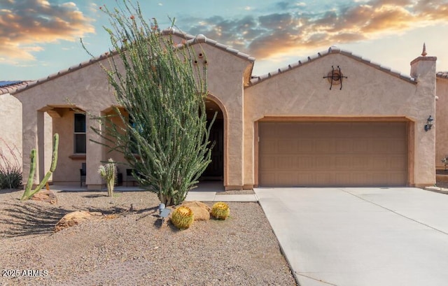 27418 W Mohawk Ln, Buckeye, AZ 85396 - view of front of property featuring a garage, stucco siding, concrete driveway, and a tile roof