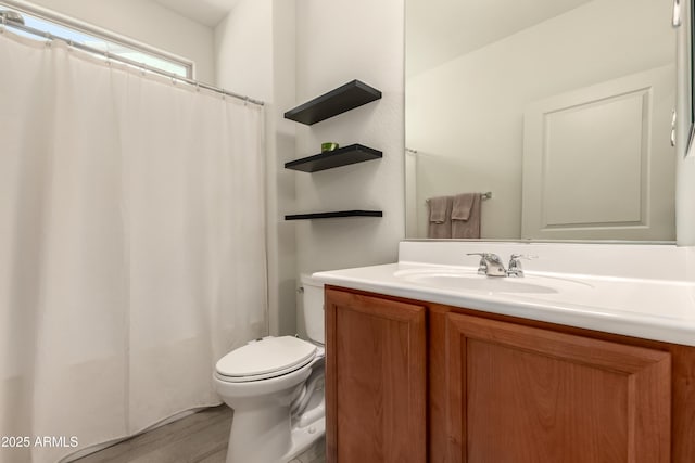 27418 W Mohawk Ln, Buckeye, AZ 85396 - bathroom with toilet, vanity, wood finished floors, and a shower with shower curtain