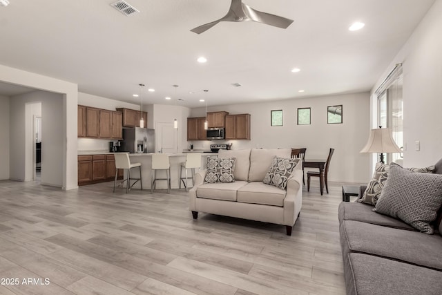 27418 W Mohawk Ln, Buckeye, AZ 85396 - living area with recessed lighting, a ceiling fan, and light wood-type flooring
