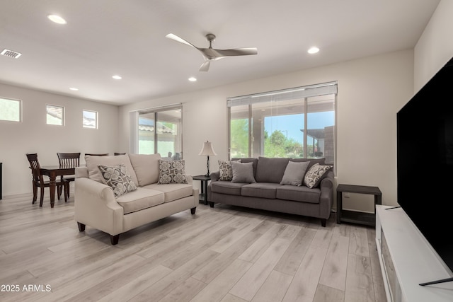 27418 W Mohawk Ln, Buckeye, AZ 85396 - living room featuring light wood-style floors, recessed lighting, and ceiling fan