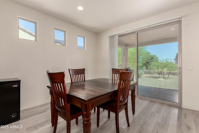 27418 W Mohawk Ln, Buckeye, AZ 85396 - dining space with light wood-style flooring, recessed lighting, and baseboards