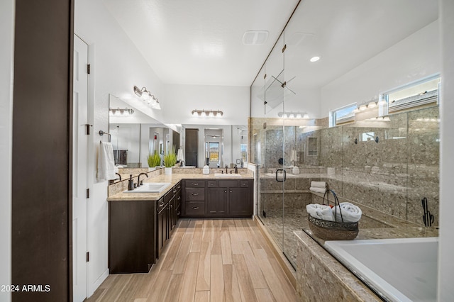 bathroom featuring hardwood / wood-style floors, vanity, and an enclosed shower