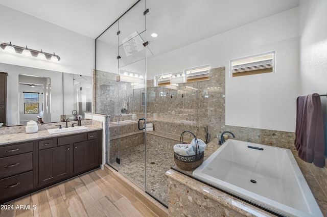 bathroom featuring vanity and independent shower and bath