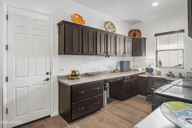 kitchen with dishwasher, dark brown cabinetry, dark hardwood / wood-style floors, and washing machine and clothes dryer